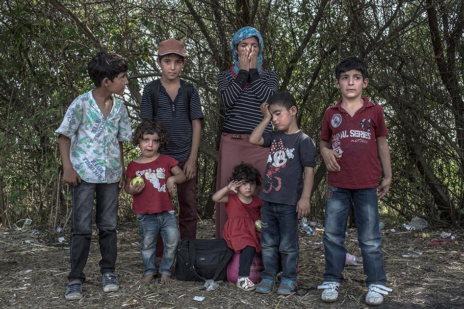 A portrait of Sabah, 35, a Syrian Kurdish refugee from Kobane, with her six children at the Serbian-Hungarian border in Röszke, Hungary, September 3, 2015.