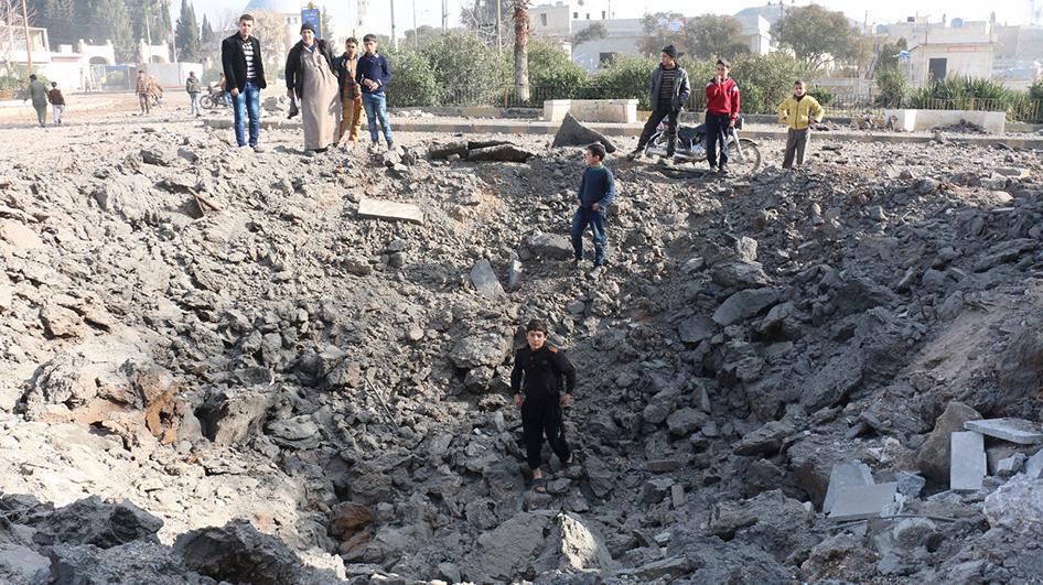 A child stands in the hole created by the impact of what local activists say was a ballistic missile. 