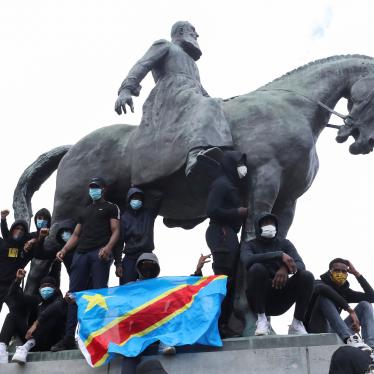Demonstrators stand on the statue of Leopold II as one of them holds a national flag of the Democratic Republic of Congo during a protest for the end of racial injustice in Brussels, Belgium, June 7, 2020.