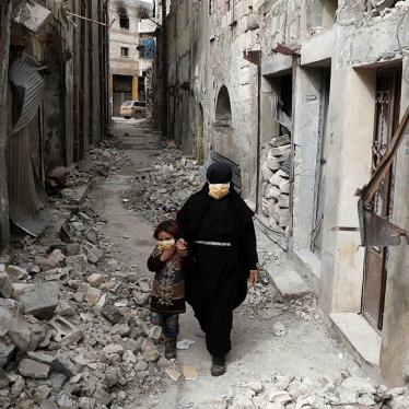 Woman and child in rubble in Idlib