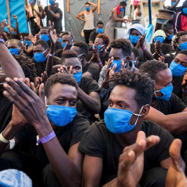 Men aboard the Sea-Watch 4, a nongovernmental rescue ship, rejoice on September 1, 2020, as they learn that they have permission to disembark in Palermo, Sicily, the next day.