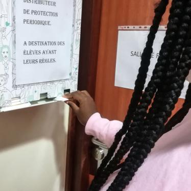 A pupil removes a free organic sanitary napkin from a dispenser at a high school
