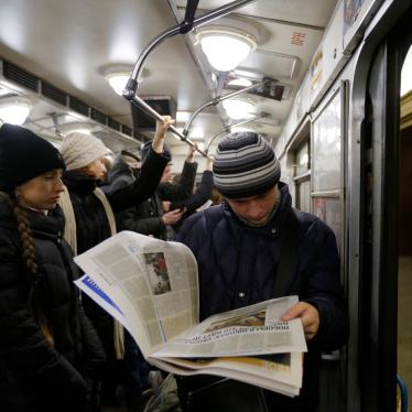 A man reads a newspaper at a metro station, in Kiev, Ukraine, February 12, 2015.