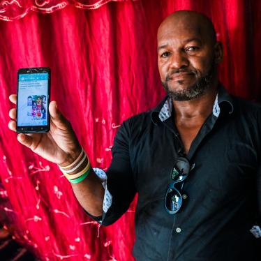 Emilio Roman, father of two young men and a daughter who were imprisoned and accused of participating in the July protests against the government, shows a picture of his children at their home in La Güinera neighborhood of Havana, March 29, 2022.