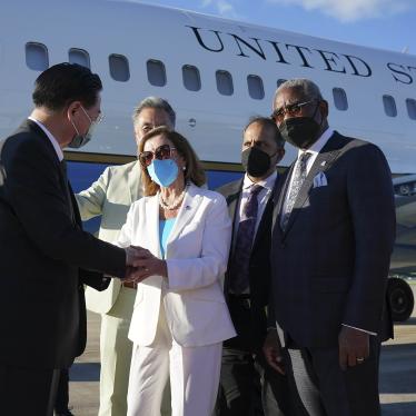 Taiwan's Foreign Minister Joseph Wu, left, speaks with US House Speaker Nancy Pelosi in front of a plane