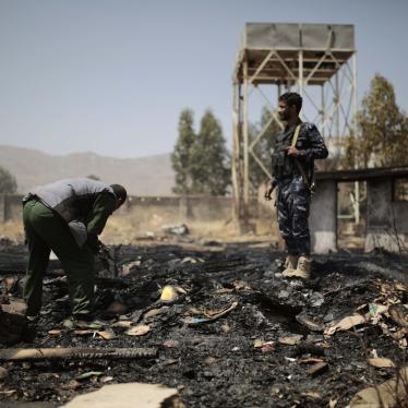 Yemeni police inspect a site of Saudi-led airstrikes that hit two houses in Sanaa, Yemen, March 26, 2022. 
