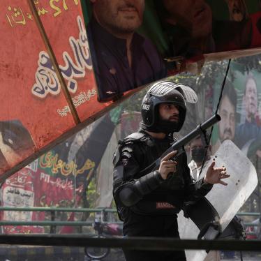 A riot police officer looks on after firing tear gas to disperse supporters of former Prime Minister Imran Khan during clashes in Lahore, Pakistan, March 15, 2023.