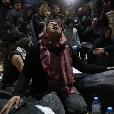 Relatives of the victims and the people of Jinderis gather in Atma city near the Syrian border with Turkey during funeral proceedings for the victims who died at the hands of Turkish-backed fighters during Newroz celebrations. 