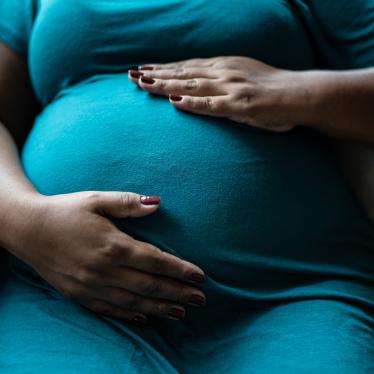  Pregnant woman touching her belly. 
