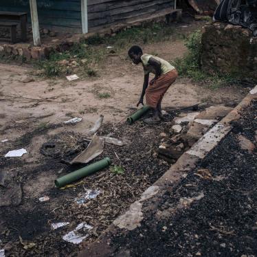 A boy collects mortar casings in the remains of a school building used as a base and allegedly destroyed by M23 fighters in Kishishe, North Kivu, Democratic Republic of Congo, April 5, 2023.