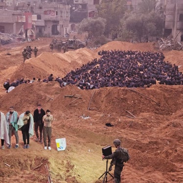 Dr. Khalid Hamoudeh (far left in the front) and Dr. Wadee Qasem (far right in the front) are detained along with other healthcare workers, internally displaced civilians, and patient’s families near the Kamal Adwan Hospital in northern Gaza.