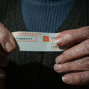 Béla, a retired agricultural worker, holds a slip of paper that confirms his monthly pension of 148,665 HUF (€376). Szabolcs-Szatmár-Bereg county, Hungary, November 2025.
