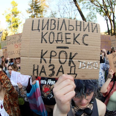 A placard reads "Civil Code Is Step Back" during a peaceful protest to urge MPs to refine the draft of the new Civil Code taking into account amendments proposed by human rights activists, in Mariinsky Park, Kyiv, Ukraine, May 5, 2026.