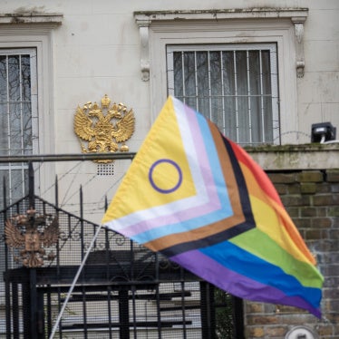 A Pride flag near the Russian coat of arms during a protest outside the Russian embassy in London, March 16, 2023.