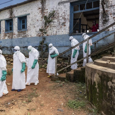 Health workers wearing protective equipment walk outside the General Referral Hospital during the Ebola outbreak response in Mongbwalu, Democratic Republic of Congo, May 21, 2026.
