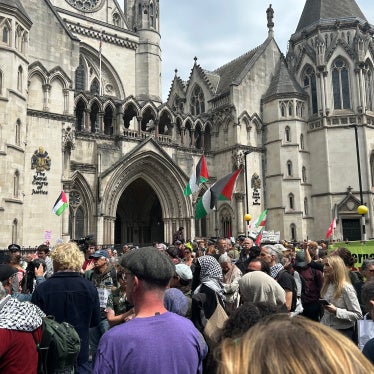 Protesters gather outside the Royal Courts of Justice on the Strand listening to the judge's statement, London, UK, June 15, 2026.