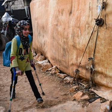 A girl walks to school at an Internally Displaced Persons (IDP) camp in the northwestern Idlib province in Syria, near the Bab al-Hawa border crossing with Turkey, on January 6, 2023.
