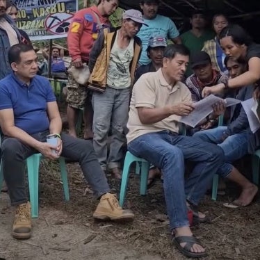 Edgardo Balgos (in blue shirt) and Fidel Santos (in cream shirt) in discussions with the residents of Kasibu, Nueva Vizcaya, Philippines.