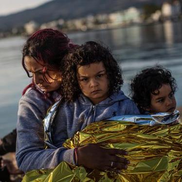 A Syrian family sit on the dock side after being escorted into the harbor by the Greek Coastguard who found them drifting offshore on June 4, 2015 in Kos, Greece. 