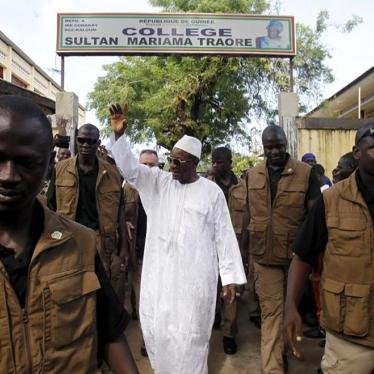 Incumbent president Alpha Conde, leader of Rassemblement du Peuple de Guinea political party, waves as he leaves the polling station during a presidential election in Conakry, Guinea on October 11, 2015.