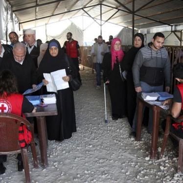 Syrian refugees line up to receive aid for the winter from the UN refugee agency (UNHCR) in Tripoli, northern Lebanon.