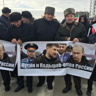 Men carrying a banner reading “Putin and Kadyrov are Russia’s foundation”. Grozny, Chechnya, January 2016. 