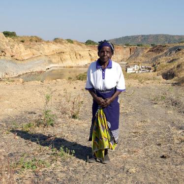 Nagomba E., 75, standing where her house used to be in Mwabulambo, Karonga district. She and her family were told to relocate in 2008 because the land was needed for coal mining. 