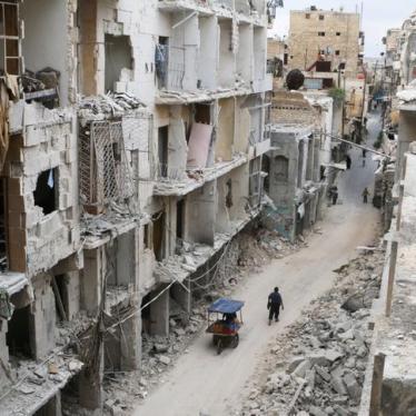 Residents walk near damaged buildings in the rebel held area of Old Aleppo, Syria on May 5, 2016. 