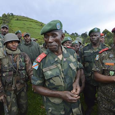 General Ilunga Kampete (right) speaks with General Bahuma Ambamba (center) near Chanzu, eastern Democratic Republic of Congo, on November 5, 2013.
