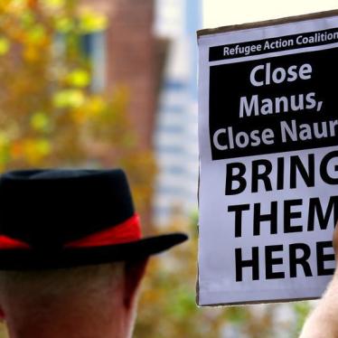 A protester from the Refugee Action Coalition holds a placard during a demonstration outside the offices of the Australian Government Department of Immigration and Border Protection in Sydney, Australia, April 29, 2016.