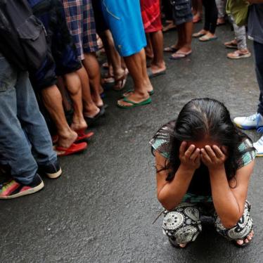 A family friend weeps after Nora Acielo, 47, was gunned down by unidentified men while escorting her two children to school in Manila, Philippines December 8, 2016.