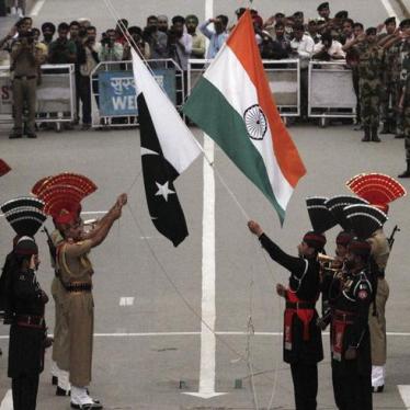 Pakistani rangers (wearing black uniforms) and Indian Border Security Force (BSF) officers lower their national flags during a daily parade at the Pakistan-India joint check-post at Wagah border, near Lahore November 3, 2014.