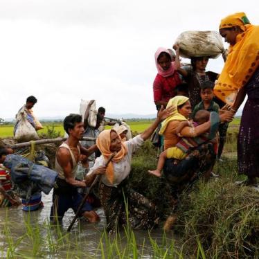A group of Rohingya refugees cross a canal after travelling over the Bangladesh-Burma border in Teknaf, Bangladesh, September 1, 2017.
