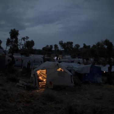 A Syrian man reads inside his tent at a makeshift camp outside Moria on the northeastern Aegean island of Lesbos, Greece.